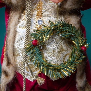 Classic Santa Claus figurine in red velvet suit with gold vest and small pine wreath