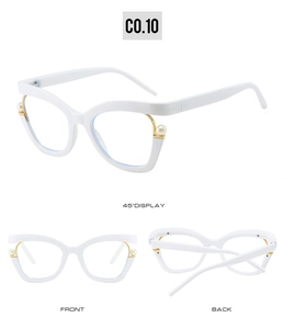 Detail of white cat-eye glasses frame with gold metal hinge and pearl accent