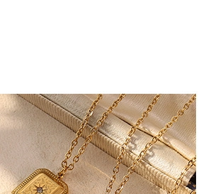 Detailed close-up of a gold square pendant with an eight-pointed star and center diamond