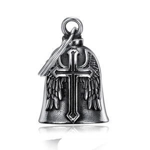 Macro view of vintage silver guardian bell featuring cross and feather wings detail