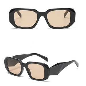 Detail view of bold geometric black sunglasses frames with gradient tea lenses