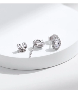 Macro detail of S925 sterling silver oval halo stud earrings with brilliant pavé stones