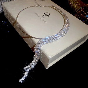 Close-up of sparkling tassel choker necklace in premium branded jewelry gift box