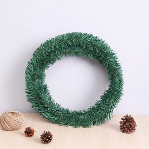 5.5m Green Christmas Pine Needle Garland with cones on wood surface for decor