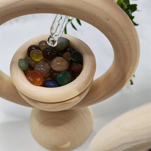 Macro detail of wood ring essential oil diffuser with polished crystal stones and dropper