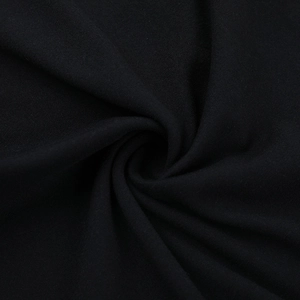 Macro shot of black knitted fabric texture showing soft spiral folds and detailed weave