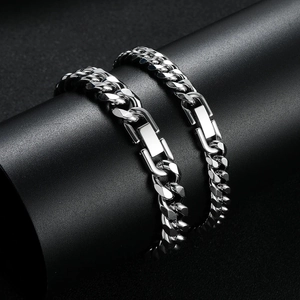 Polished silver stainless steel Cuban link bracelets for men on black display