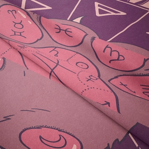Detail of bohemian tapestry featuring pink and purple constellation patterns on soft fabric