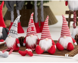 Detailed view of four festive Christmas gnomes with knitted hats on a wooden tray