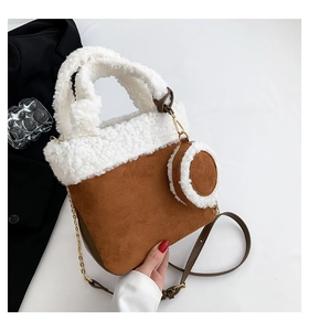 Detail of faux shearling bucket bag with brown suede trim and matching mini coin purse
