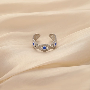 Minimalist stainless steel evil eye open ring for women on smooth beige silk fabric