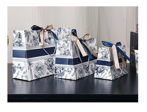 Detailed view of three-piece floral gift bags with elegant ribbons and butterfly patterns