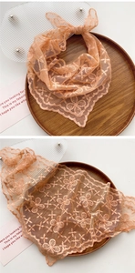 Close-up of orange-pink lace embroidery triangle scarf with clover floral mesh patterns