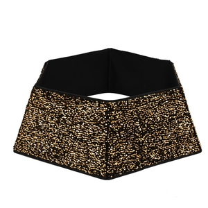 Detail of hexagonal Christmas tree collar with shimmering gold sequins on black fabric