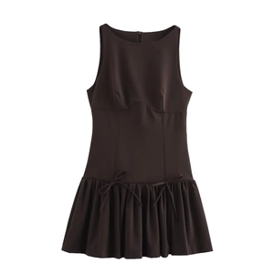 Detail of coffee brown sleeveless mini dress featuring bow-knot waist and pleated skirt hem