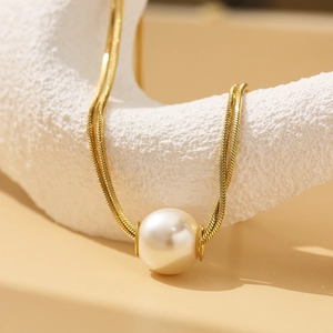 Elegant gold snake chain necklace featuring a large lustrous white pearl pendant for women