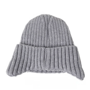 Close-up of grey knit winter hat featuring thick ribbed pattern and wide folded cuff
