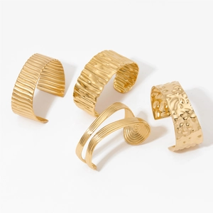 Set of four gold stainless steel wide open bangles with hammered and wave textures