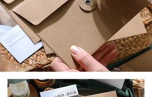 Detail of vintage kraft paper envelope with string tie closure and decorative cards