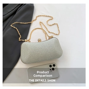 Detailed view of a silver glitter clutch bag with gold handle and chain next to a phone