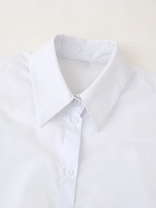Close-up detail of the classic collar and button placket on a white sporty shirt