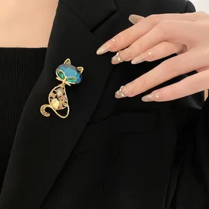 Elegant gold hollow fox brooch with blue gemstone pinned on a black suit lapel