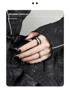 Detail of dark textured S925 silver open rings with irregular lava finish on model hand