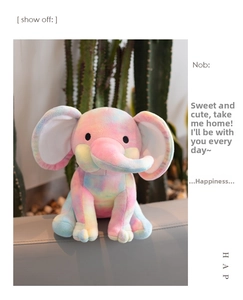 Detail of soft tie-dye elephant plush toy with colorful rainbow gradient and large ears