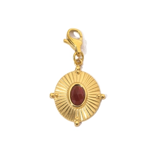 Detail of a golden sun pendant with an oval red gemstone and durable lobster clasp