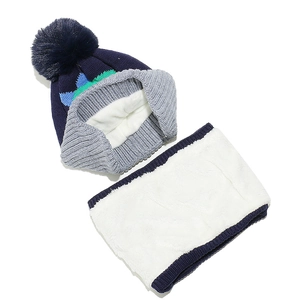Detail of blue knitted kids winter set showing thick white plush lining and soft texture