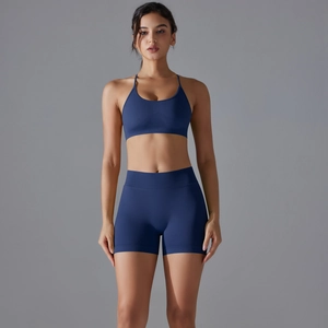 Front view of seamless navy blue yoga set with racerback sports bra and high waist shorts