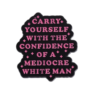 Pink enamel badge with Confidence of a Mediocre White Man quote on white background