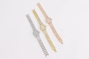 Close-up of sparkling full crystal metal quartz watches in silver, gold, and rose gold