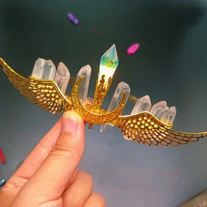 Macro detail of handmade gold wire hair crown with moon, wings, and natural crystals