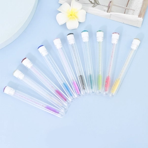 Detail of disposable lash brushes in clear tubes with sparkling crystal handles