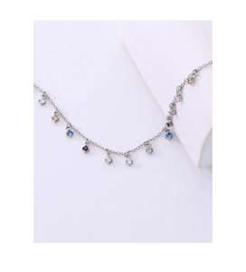Macro detail of silver necklace with colorful round-cut cubic zirconia tassel charms