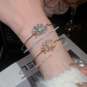 Close-up of zircon firework and pearl double-layer stackable bracelets on a female wrist