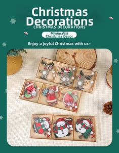 Detailed view of three handcrafted wooden Christmas ornaments featuring elk and Santa Claus
