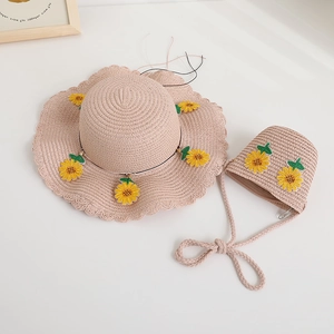 Dettaglio del set cappello e borsa di paglia rosa con ricamo di girasoli e bordi ondulati