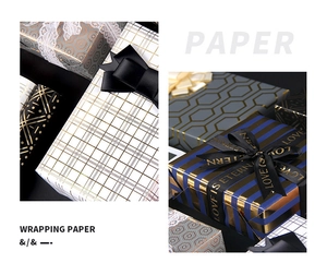 Detail of luxury geometric gift wrapping paper with gold stamping and satin ribbon bows