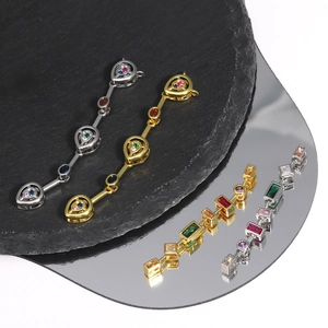 Detailed view of silver and gold long tassel pendants with colorful zircon gemstones