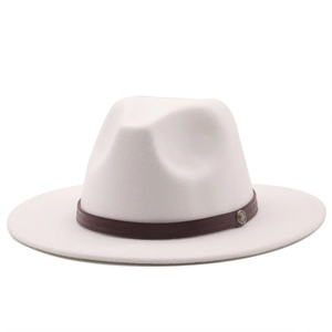 Detail of cream wool fedora hat with brown leather band and round metal badge