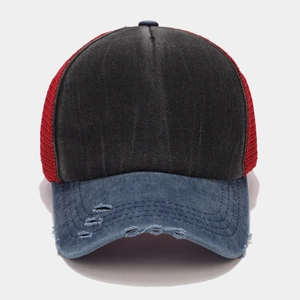 Detail of distressed brim and breathable mesh on a color-block vintage trucker hat
