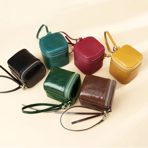 Detailed view of leather mini elephant coin purses in various colors with wrist straps