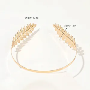 Detail shot of golden laurel leaf headband showing intricate vein textures and metal finish