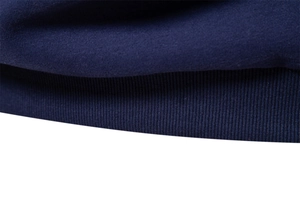 Macro view of tight ribbed knit cuffs on a navy blue long-sleeved polo sweatshirt