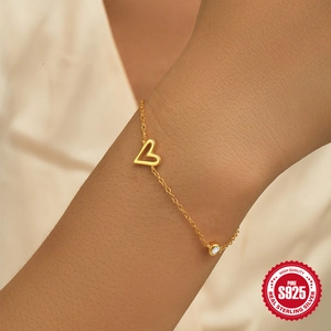 Classic S925 sterling silver gold heart bracelet with sparkling zircon on a female wrist