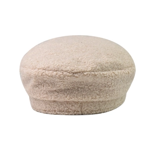 Detailed texture of a beige sherpa beret hat with soft grainy fabric and minimalist design