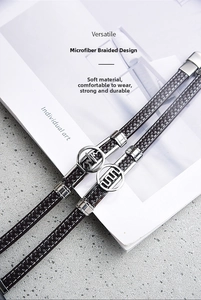 Detailed view of woven microfiber bracelets with infinity pulse and geometric metal charms