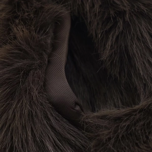 Detailed macro view of dark coffee faux fur texture and matching twill fabric lining
